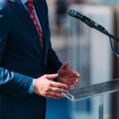 Man in suit standing by microphone