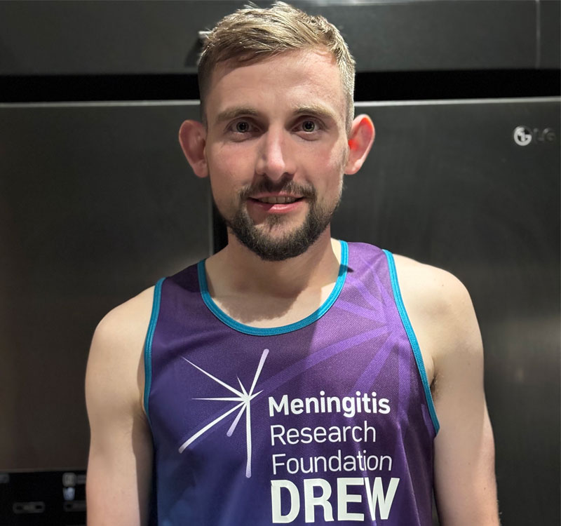 Drew Darlington in his Meningitis Research Foundation running vest